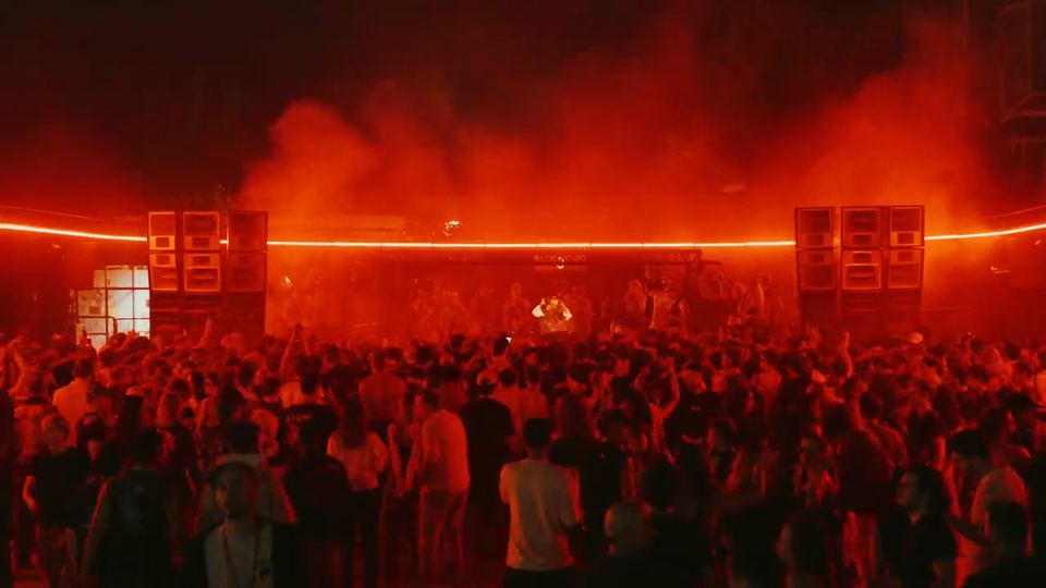 La foule sous les lumières rouges, à la nuit tombée, anniversaire GRÜV 3 ans