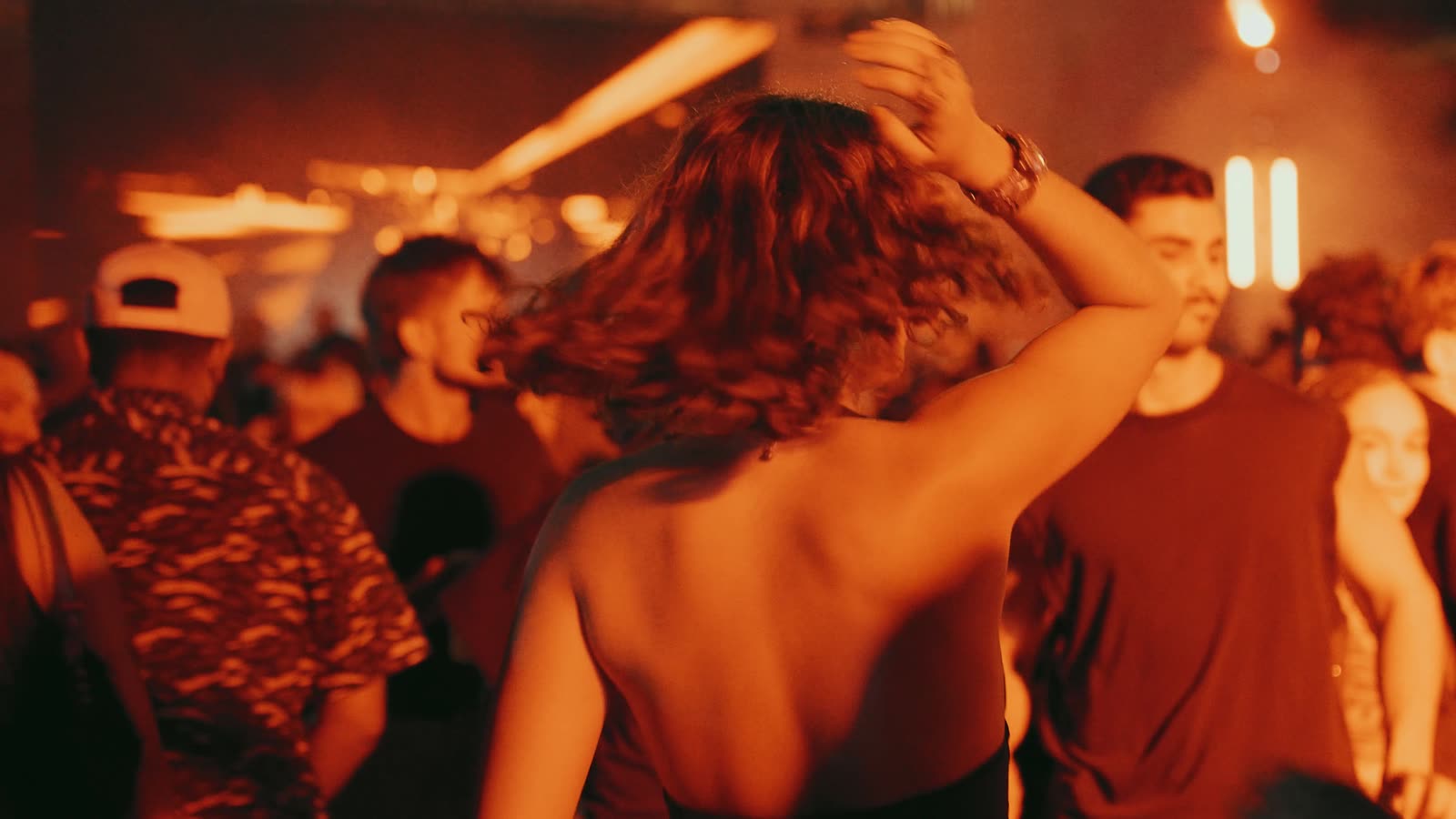 The crowd dancing under orange light during Perc’s set, RAW Open-air